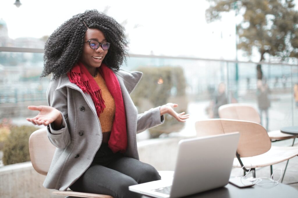 Happy woman in front of laptop