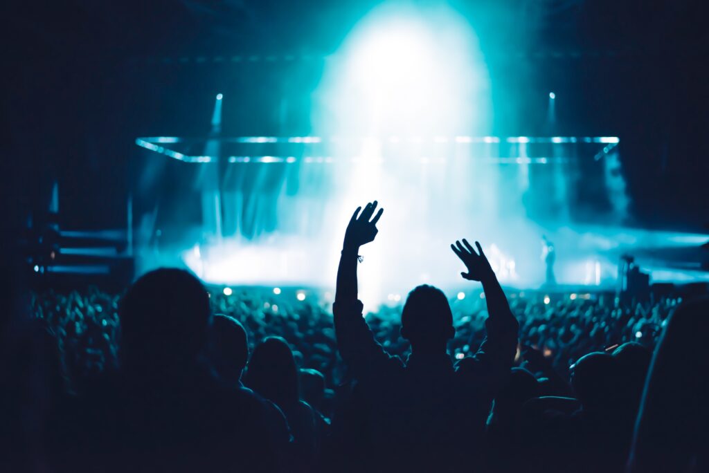 audience with hands up at a concert