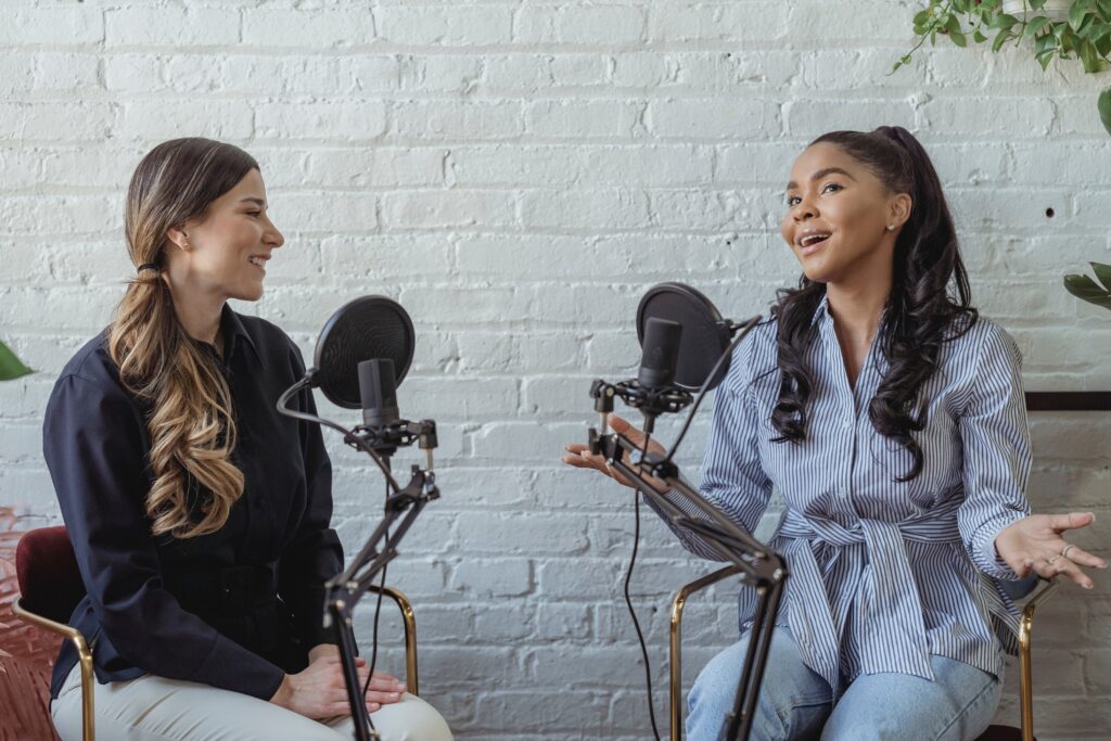 Two women having a discussion in front of two microphones